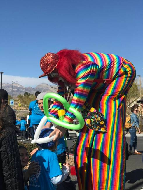 Charlie the Clown makes balloon crowns for children during Walk4Friendship at Bet Yossef Commun ...