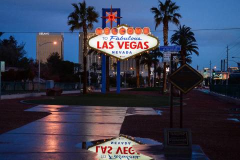 Rain puddles are seen at the Welcome to Fabulous Las Vegas sign in February 2019. (Las Vegas Re ...
