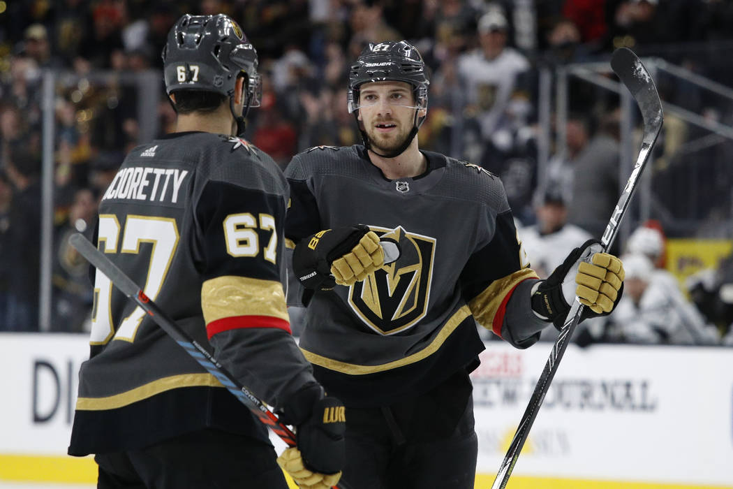 Vegas Golden Knights defenseman Shea Theodore, right, celebrates after scoring against the Los ...