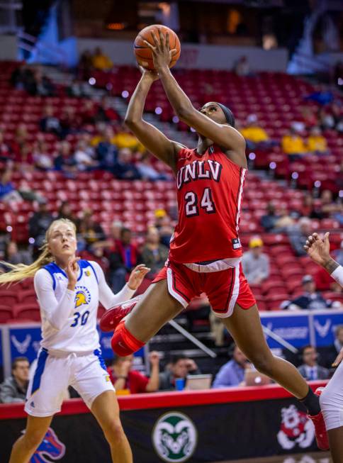 UNLV Lady Rebels guard Rodjanae Wade (24, center) catches some air as she sets up a shot past S ...