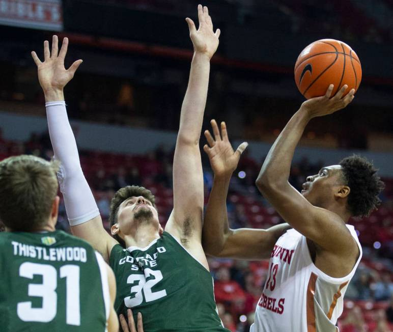 UNLV Rebels guard Bryce Hamilton (13) shoots over Colorado State Rams forward Adam Thistlewood ...