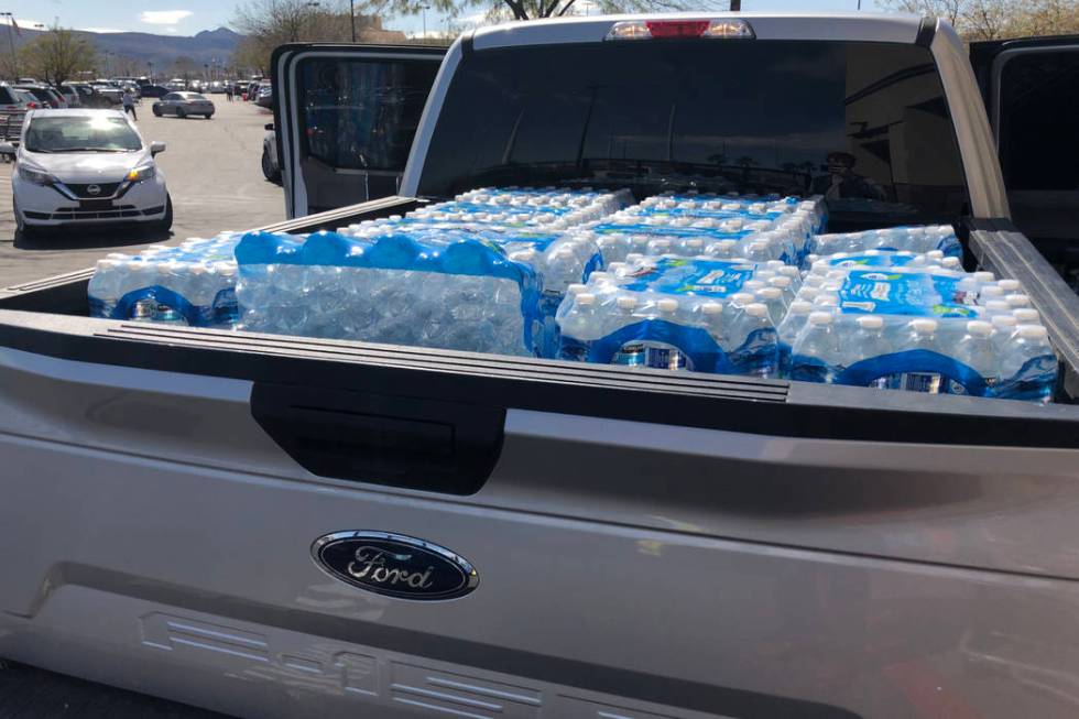 Cases of water are loaded into a truck at Costco Wholesale in Henderson on Monday, March 2, 202 ...