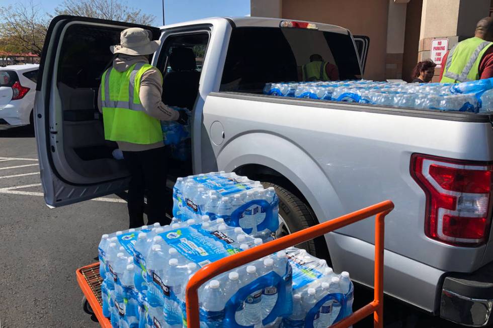 Cases of water are loaded into a truck at Costco Wholesale in Henderson on Monday, March 2, 202 ...