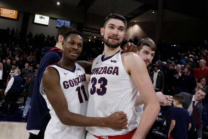 Gonzaga guard Joel Ayayi (11) and forward Killian Tillie (33) embrace after the final home game ...