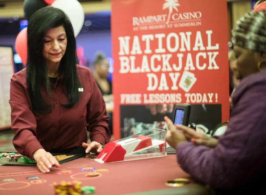 Izzy, a blackjack dealer, deals for Barbara Wright, right, of Las Vegas, at Rampart Casino in L ...