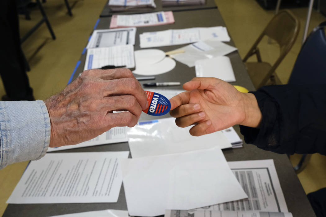 Early voter receives his I-Voted sticker, at an early voting polling station at the Ranchito Av ...