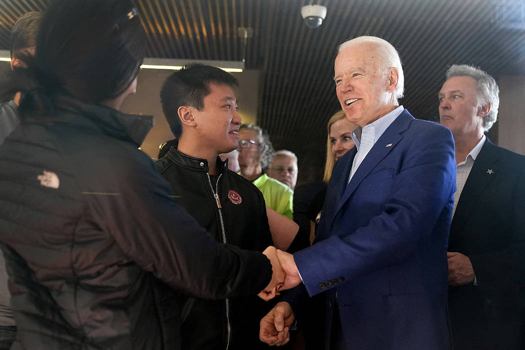 Democratic presidential candidate former Vice President Joe Biden shakes hands with customers a ...