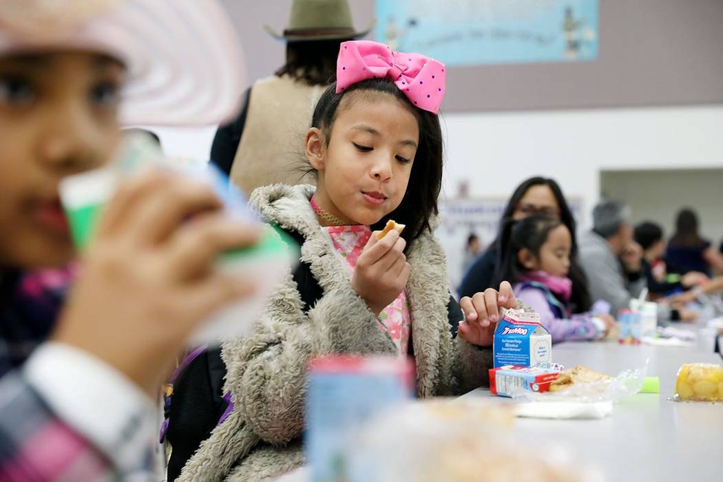 Ayumi Rivers, 10, eats her breakfast during the Clark County School District's first day of uni ...