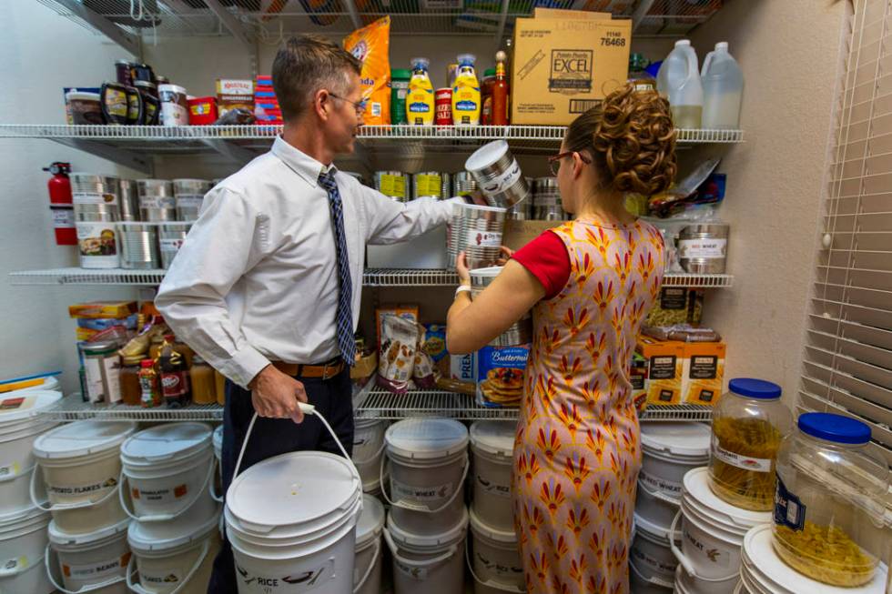 Cory, left, and Holly Steed sort through some of the food items stored in their home pantry on ...