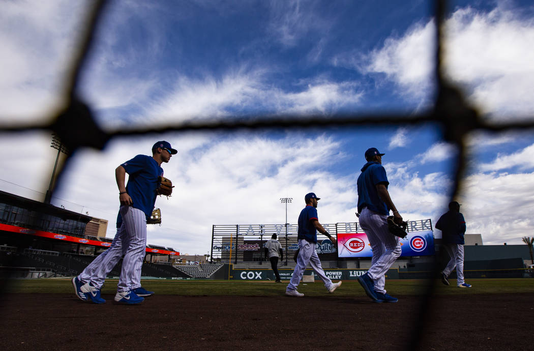 Chicago Cubs players take the field to warm up before a baseball game against the Cincinnati Re ...
