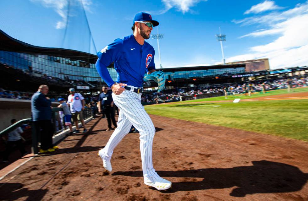 Chicago Cubs' Kris Bryant runs onto the field before the start of a baseball game against the C ...