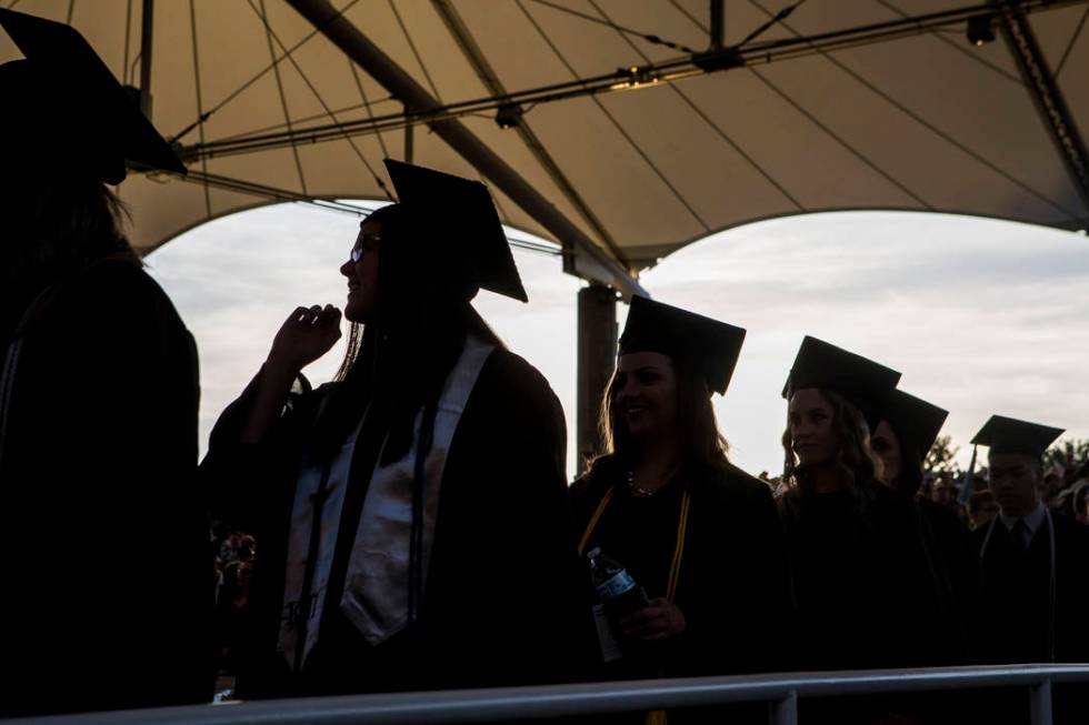 Graduates make their way down the aisle to their seats at Nevada State College's commencement c ...