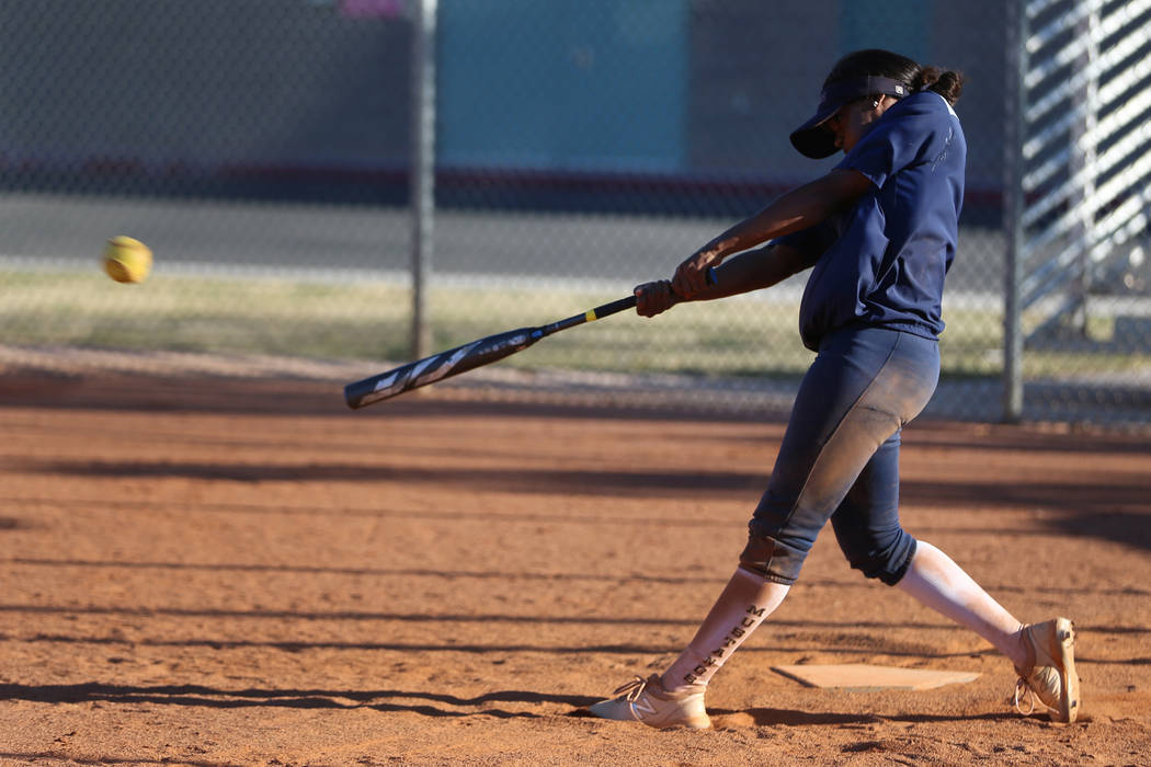 Shadow Ridge's Jasmine Martin, 17, connects with the ball during a softball practice at Shadow ...