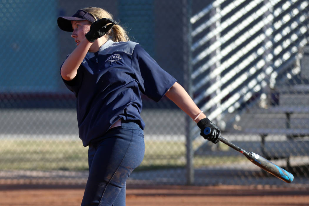 Shadow Ridge's Hailey Morrow, 16, connects with the ball during a softball practice at Shadow R ...