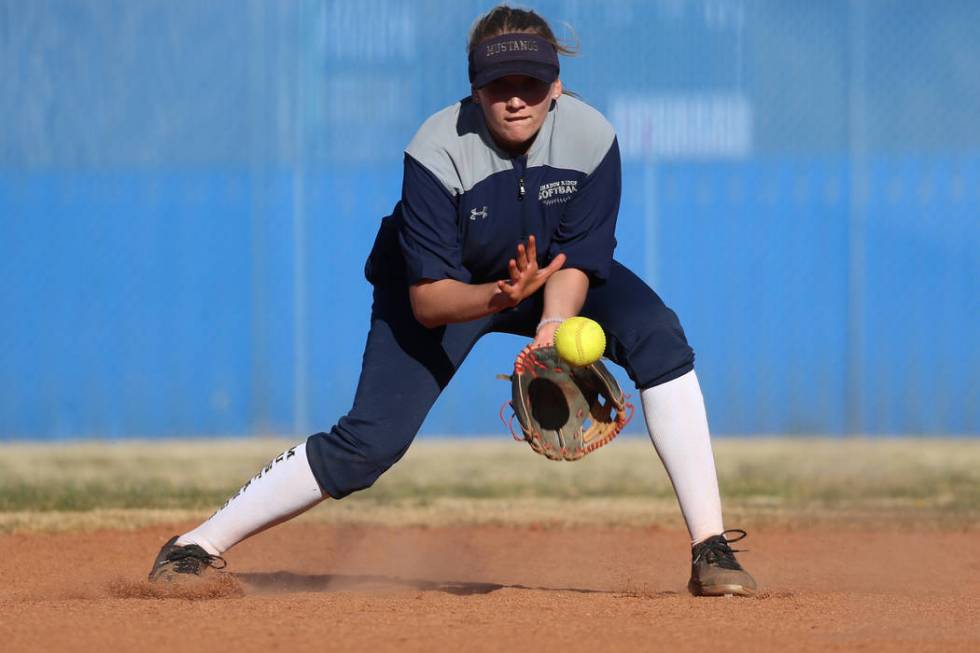 Shadow Ridge's Hailey Morrow, 16, reaches for a ground ball during a softball practice at Shado ...