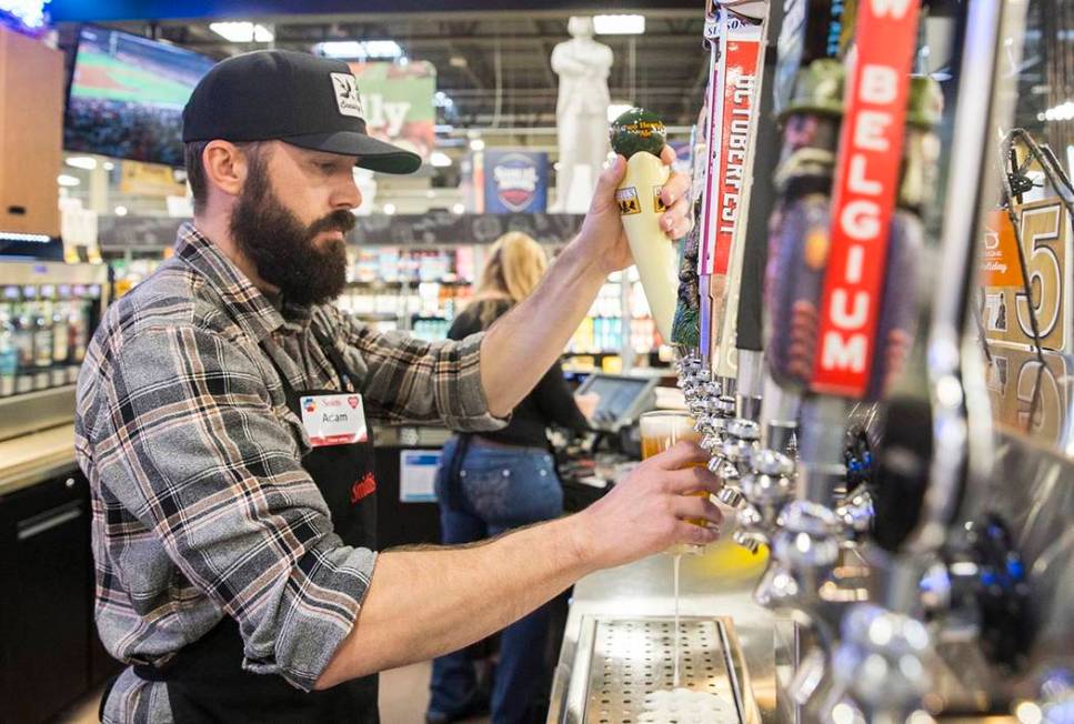 Bartender Adam Karli pours a beer at Social Hour Beer and Wine Bar on Thursday, Oct. 10, 2019, ...