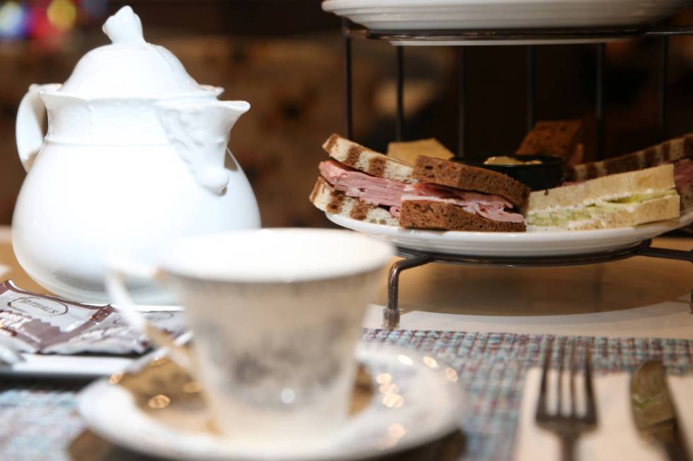 The tea party for two is served with tea, pastries and finger sandwiches with ham, roast beef a ...