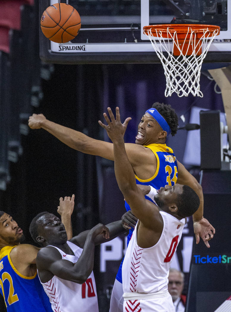 San Jose State Spartans forward Ralph Agee (35, above) swats away a shot by New Mexico Lobos gu ...