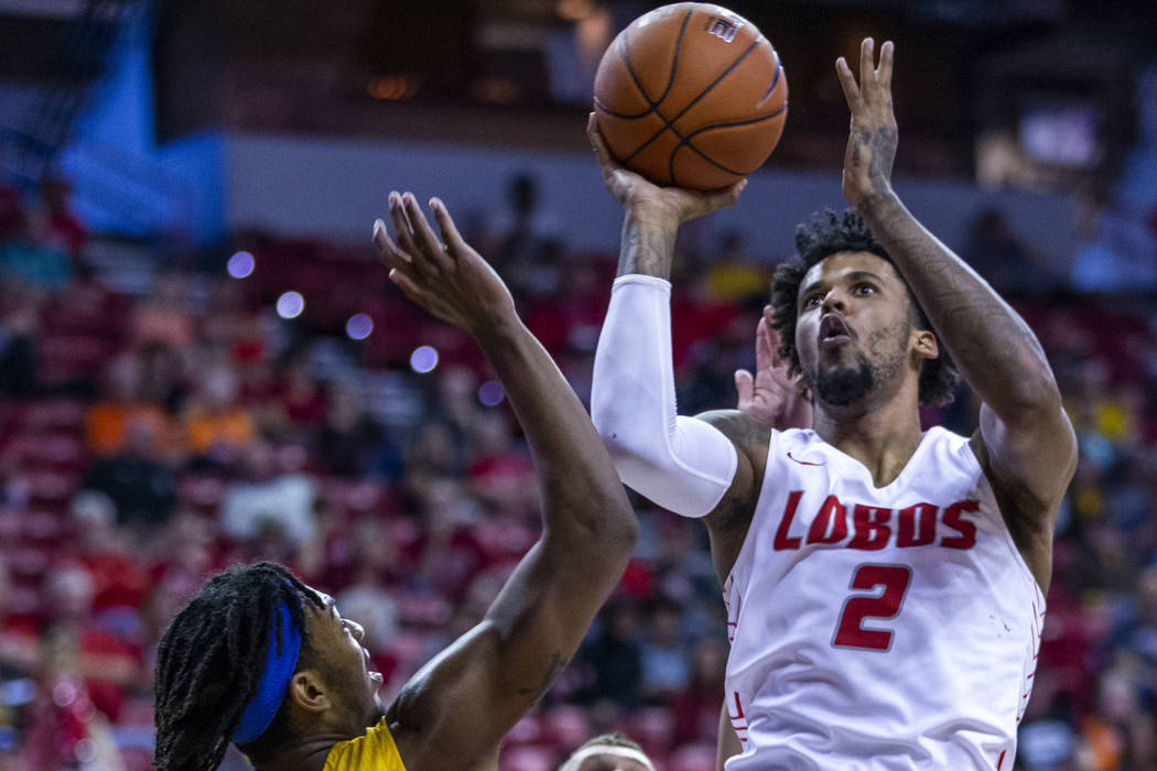 New Mexico Lobos guard Vance Jackson (2), right, gets off a jump shot between San Jose State Sp ...