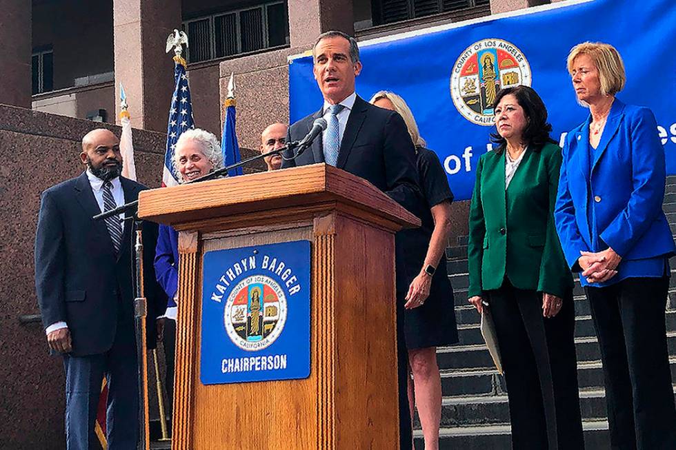 Los Angeles Mayor Eric Garcetti speaks at a news conference that announced that six new cases o ...