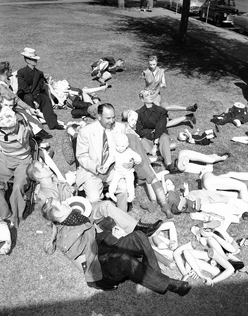 Hillman Lee, manager of a department store, is surrounded by mannequins and mannequin parts whi ...