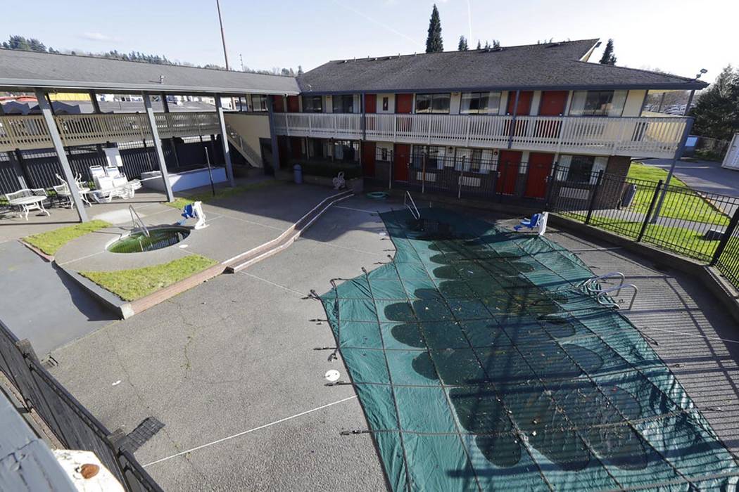 The pool and courtyard area of an Econo Lodge motel in Kent, Wash., is shown Wednesday, March 4 ...