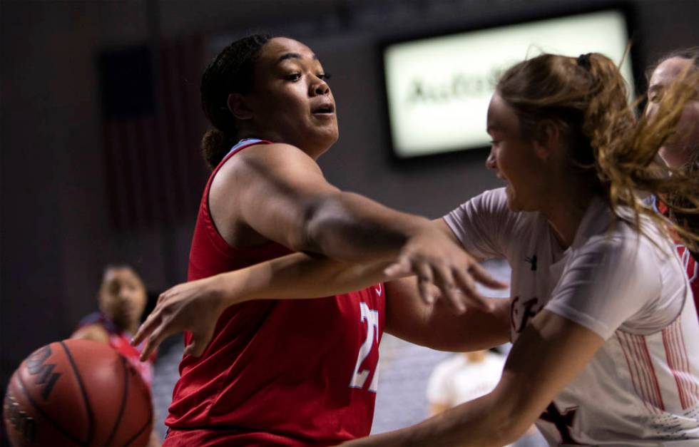 Loyola Marymount's center Raychel Stanley (22) blocks Saint Mary's guard Taycee Wedin (4) durin ...