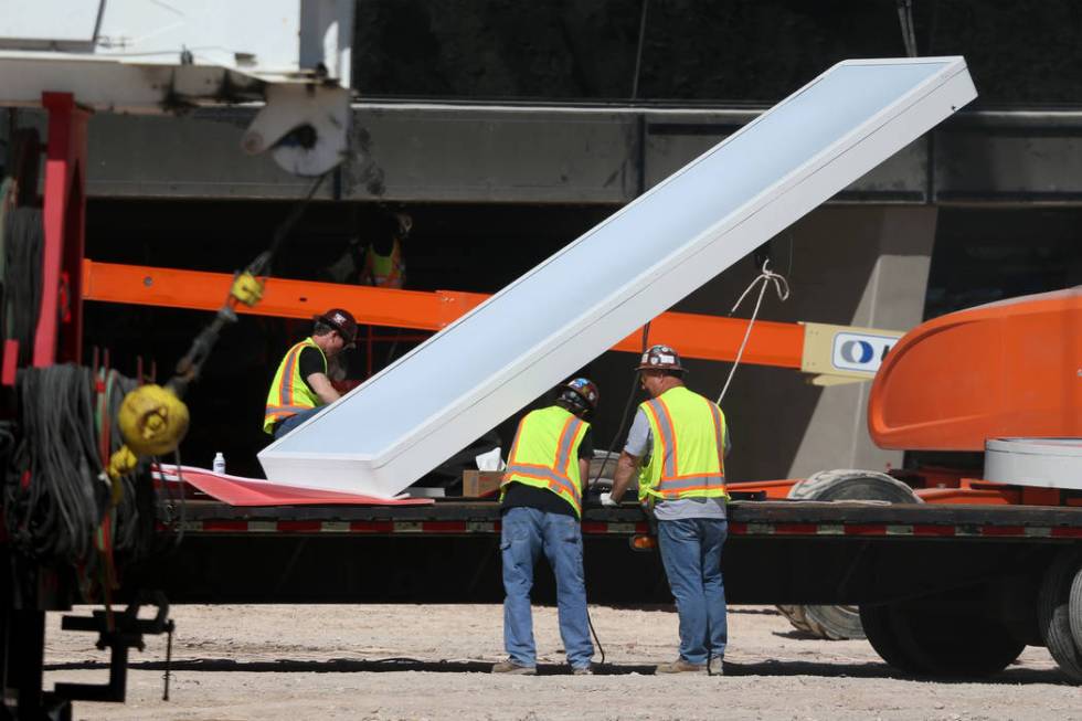 The sign at the Raiders Allegiant Stadium in Las Vegas gets prepared to be installed, Thursday, ...