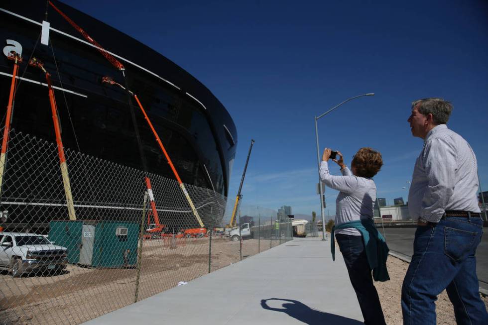 Sharon Miller, left, and her brother John Meesig of Ohio, document the signage getting installe ...