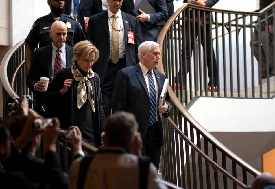 Vice President Mike Pence, center, joined at left by Dr. Deborah Birx, the coronavirus response ...