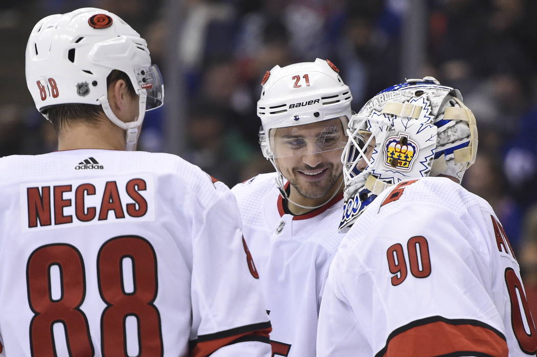 Carolina Hurricanes right wing Nino Niederreiter (21) and center Martin Necas (88) speak to Hur ...