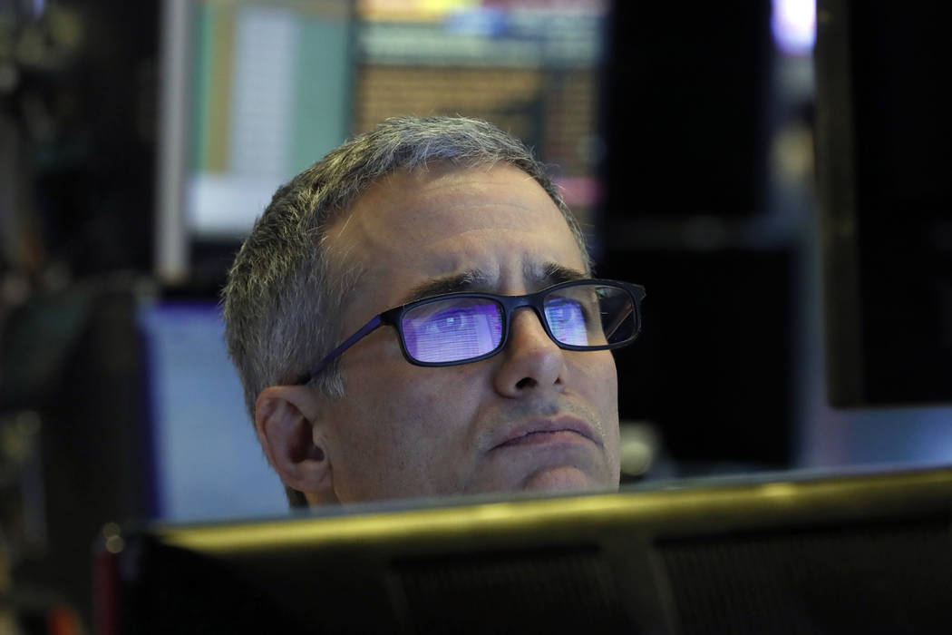 Specialist Anthony Rinaldi prepares for the day's trading, on the floor of the New York Stock E ...
