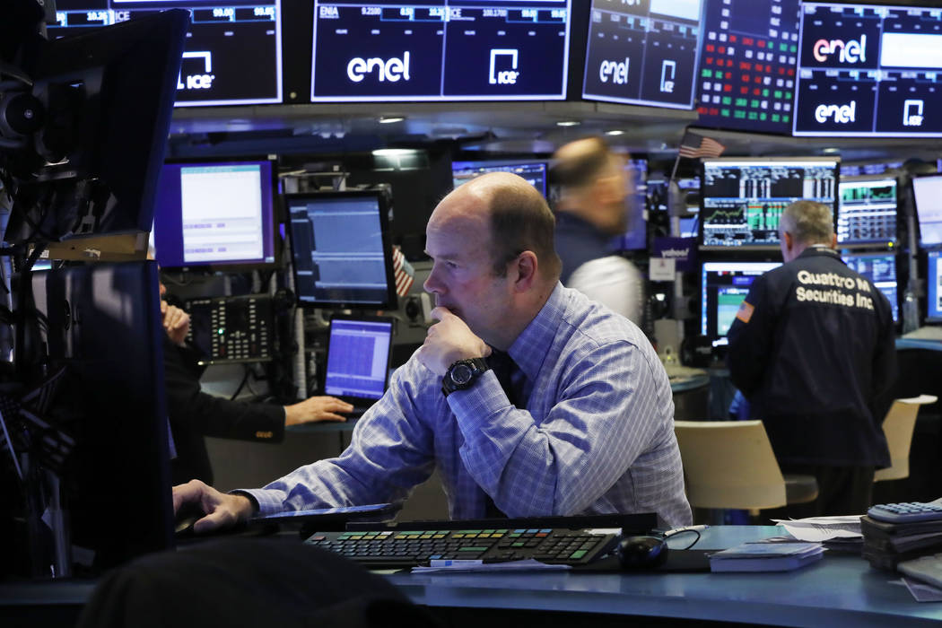 Trader Peter Mancuso prepares for the day's trading, on the floor of the New York Stock Exchang ...