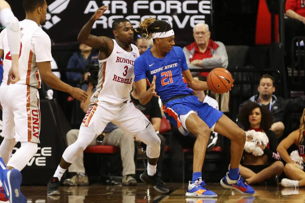 UNLV Rebels guard Amauri Hardy (3) defends against Boise State Broncos guard Derrick Alston (21 ...