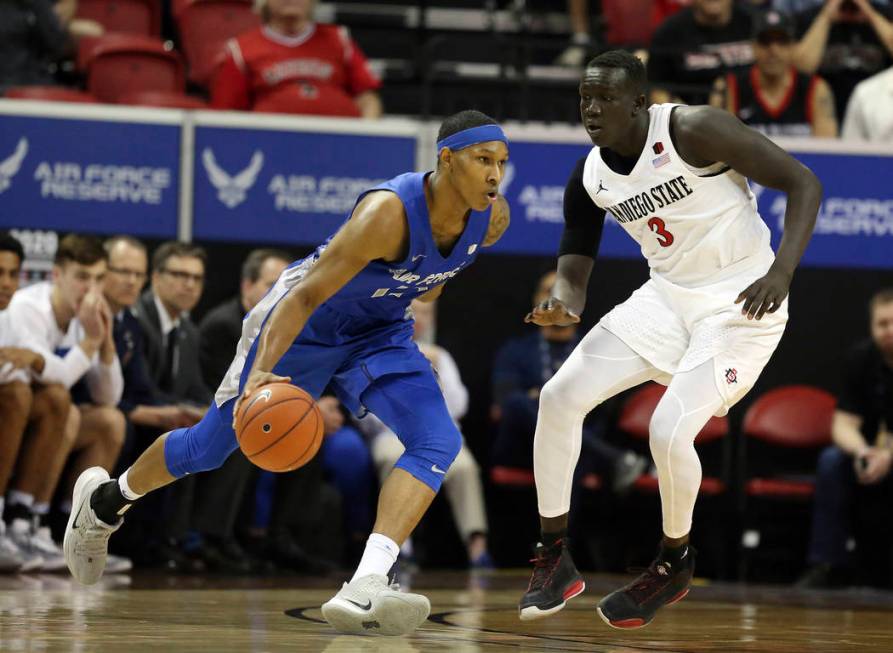 Air Force's Lavelle Scottie drives as San Diego State's Aguek Arop defends during the second ha ...