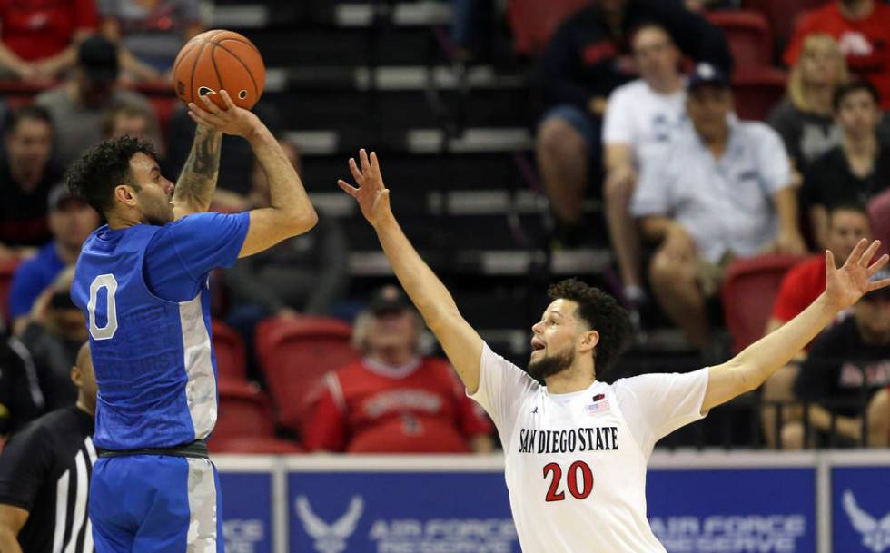 Air Force's Caleb Morris shoots as Jordan Schakel defends during the second half of a Mountain ...