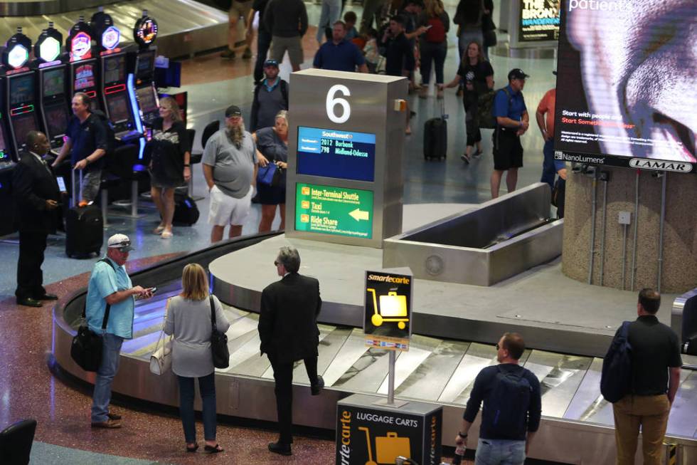 Passengers wait for their luggage in Terminal 1 at McCarran International Airport in Las Vegas, ...