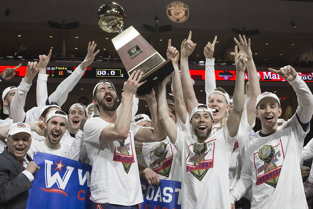 Saint Mary's hoists the trophy after upsetting Gonzaga 60-47 to win the West Coast Confere ...