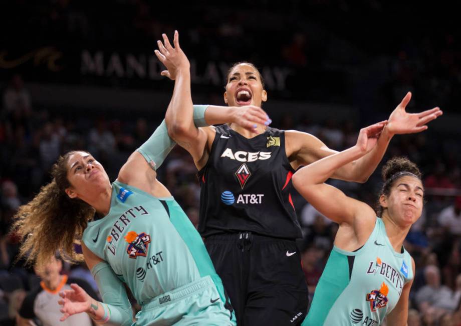 Las Vegas Aces center Liz Cambage (8) fights for position with New York Liberty center Amanda Z ...