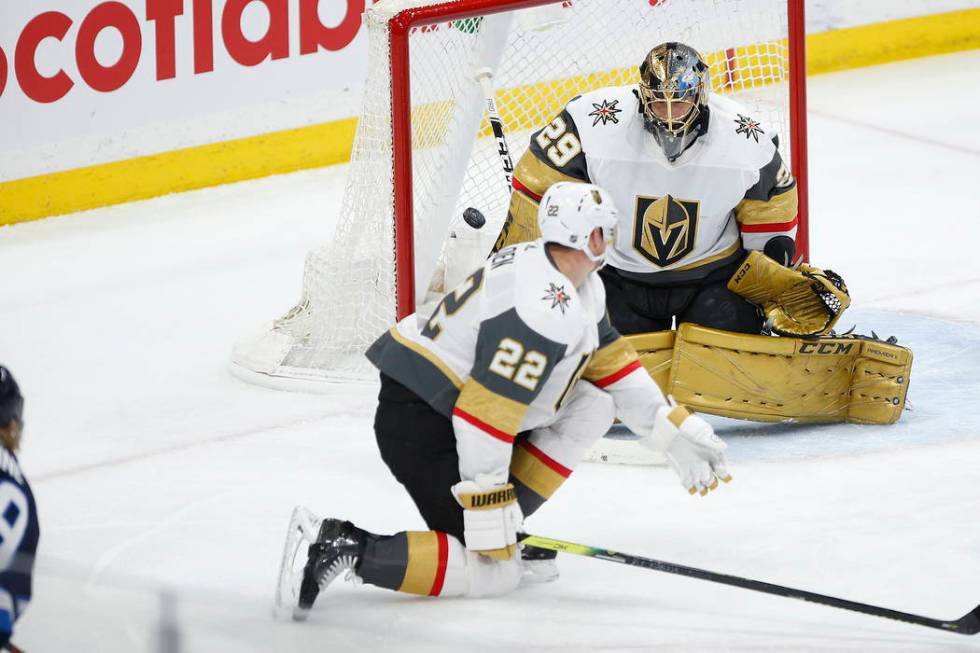 A shot by Winnipeg Jets' Patrik Laine, just out of frame at left, gets past Vegas Golden Knight ...