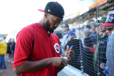 Cincinnati Reds pitchers Amir Garrett signs an autograph during a live batting practice event a ...