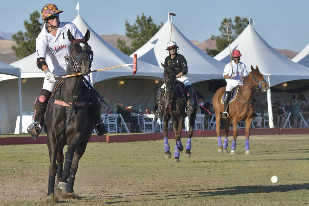 Jennifer Luttrell Benardoni, left, of team UBS hits a shot at the goal during the Las Vegas Pol ...