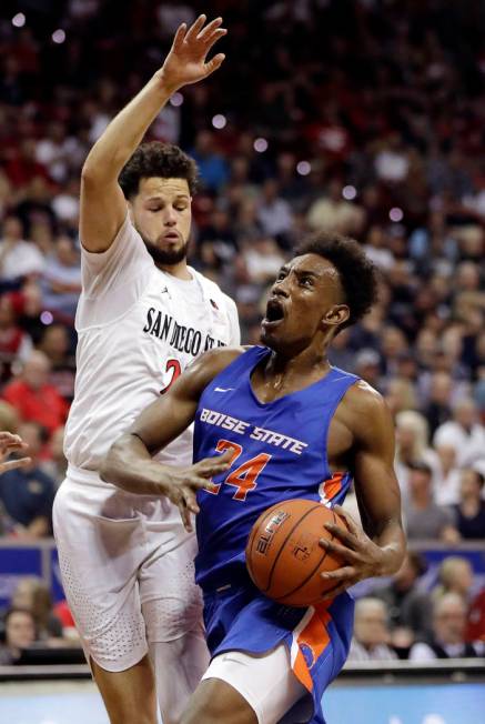 Boise State's Abu Kigab drives as San Diego State's Jordan Schakel defends during the first hal ...