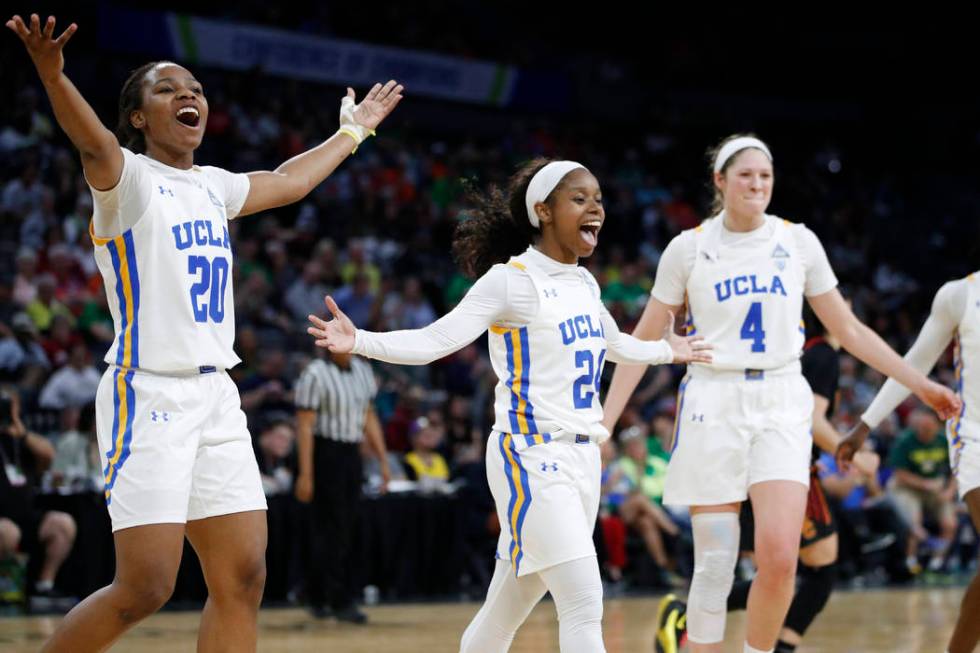 UCLA's Charisma Osborne, left, Japreece Dean, center, and Lindsey Corsaro celebrate after a pla ...