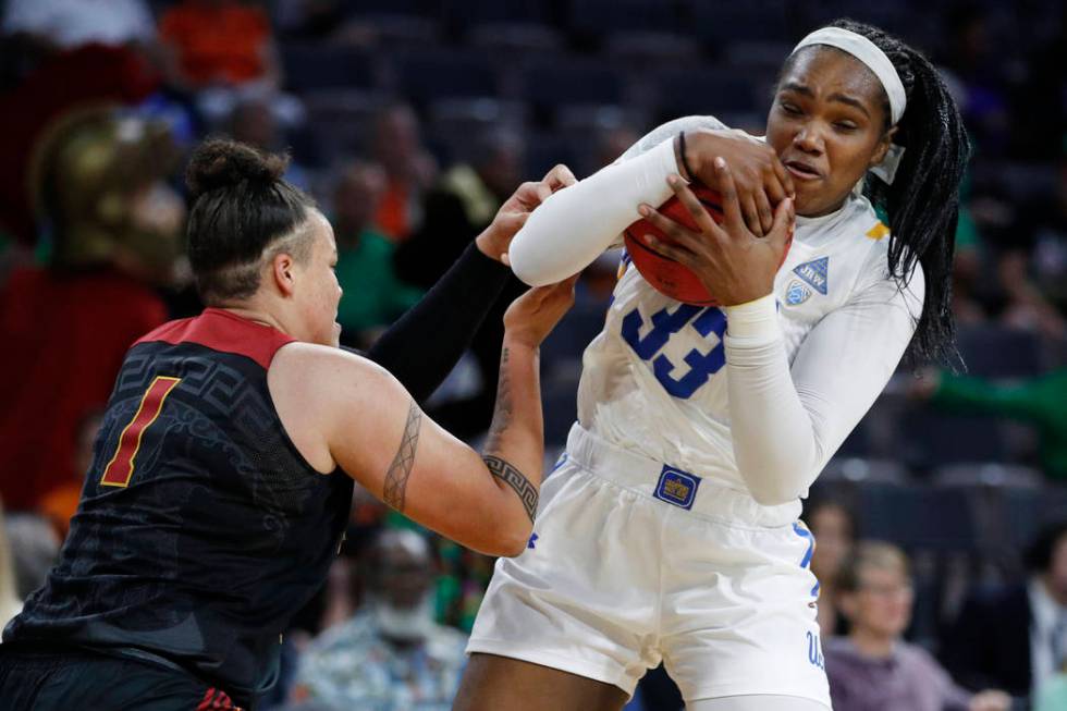 UCLA's Lauryn Miller (33) grabs a rebound over Southern California's Kayla Overbeck (1) during ...