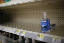 FILE - In this Feb. 28, 2020 file photo, rows of hand sanitizer are seen empty at a Walgreens i ...