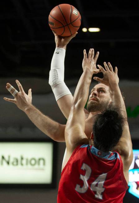 San Francisco Dons center Jimbo Lull (5) shoots over Loyola Marymount Lions forward Keli Leaupe ...