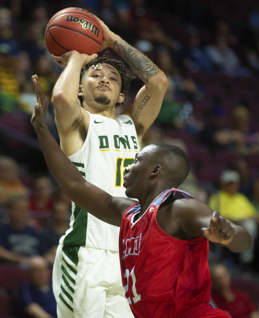 San Francisco Dons guard Trevante Anderson (12) shoots over Loyola Marymount Lions guard Seikou ...