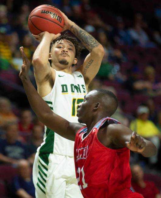 San Francisco Dons guard Trevante Anderson (12) shoots over Loyola Marymount Lions guard Seikou ...