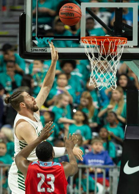 San Francisco Dons center Jimbo Lull (5) shoots over Loyola Marymount Lions forward Jordan Bell ...